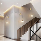 KCO Lighting Modern Gold Globe Wall Sconce Mid Century Raw Brass Round Glass Wall Mounted Light Minimalist Vanity Adjustable Cord Wall Lamp for Bathroom Mirror Bedside Stairs (Amber)